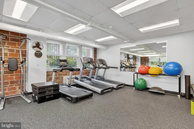 a kitchen with stainless steel appliances wooden floor and window
