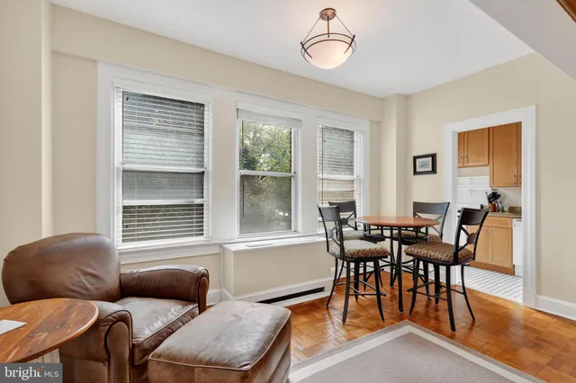 a dining room with furniture and wooden floor
