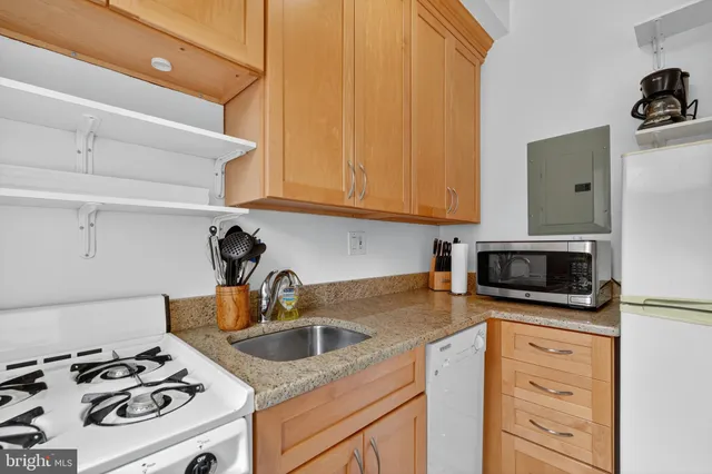 a kitchen with white cabinets and appliances