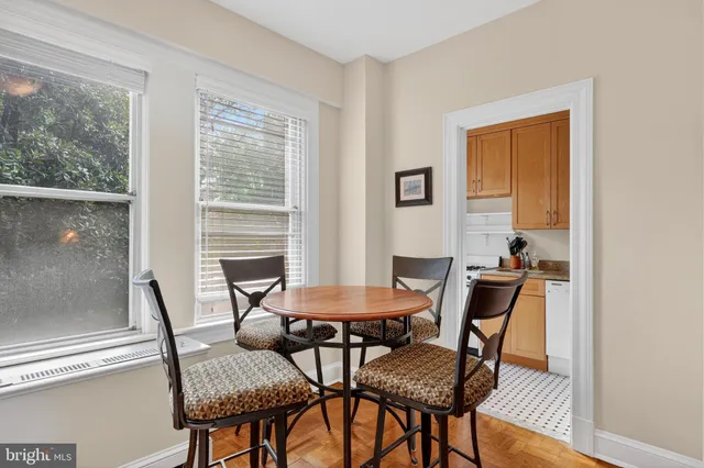 a dining room with furniture and window