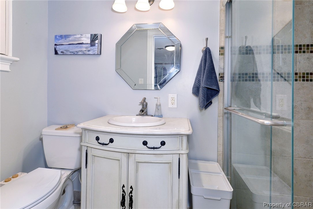 122 Selden Road Newport News, VA 23606 - Photo 14 of 38 Bathroom on lowest level off of utility room with an enclosed shower, vanity, and mirror