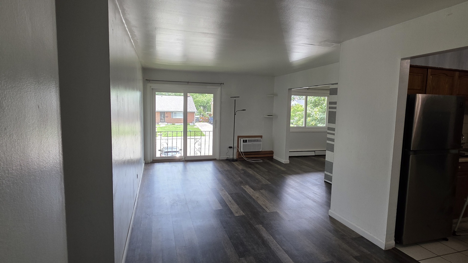9446 Dee Road, Unit 2E Des Plaines, IL 60016 - Photo 14 of 37 an empty room with wooden floor and windows