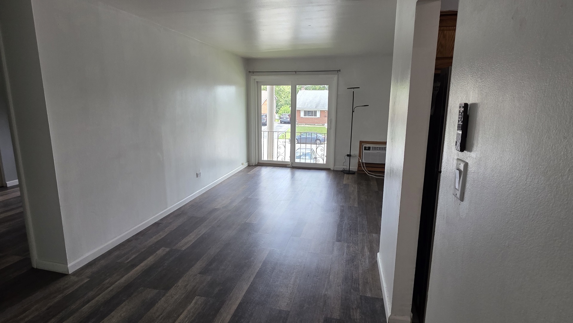 9446 Dee Road, Unit 2E Des Plaines, IL 60016 - Photo 15 of 37 a view of an empty room with wooden floor and a window