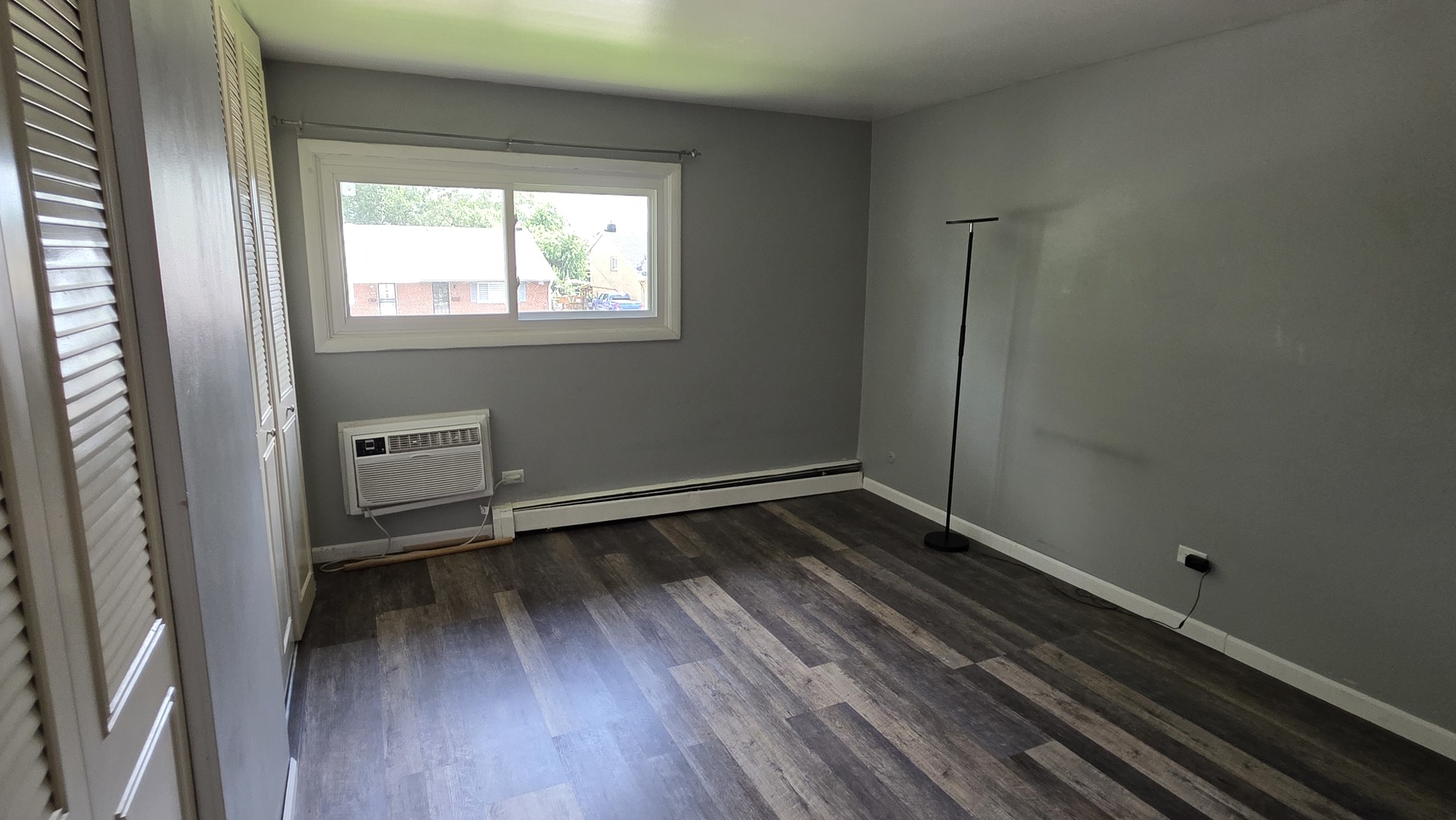 9446 Dee Road, Unit 2E Des Plaines, IL 60016 - Photo 18 of 37 a view of a room with wooden floor and a window