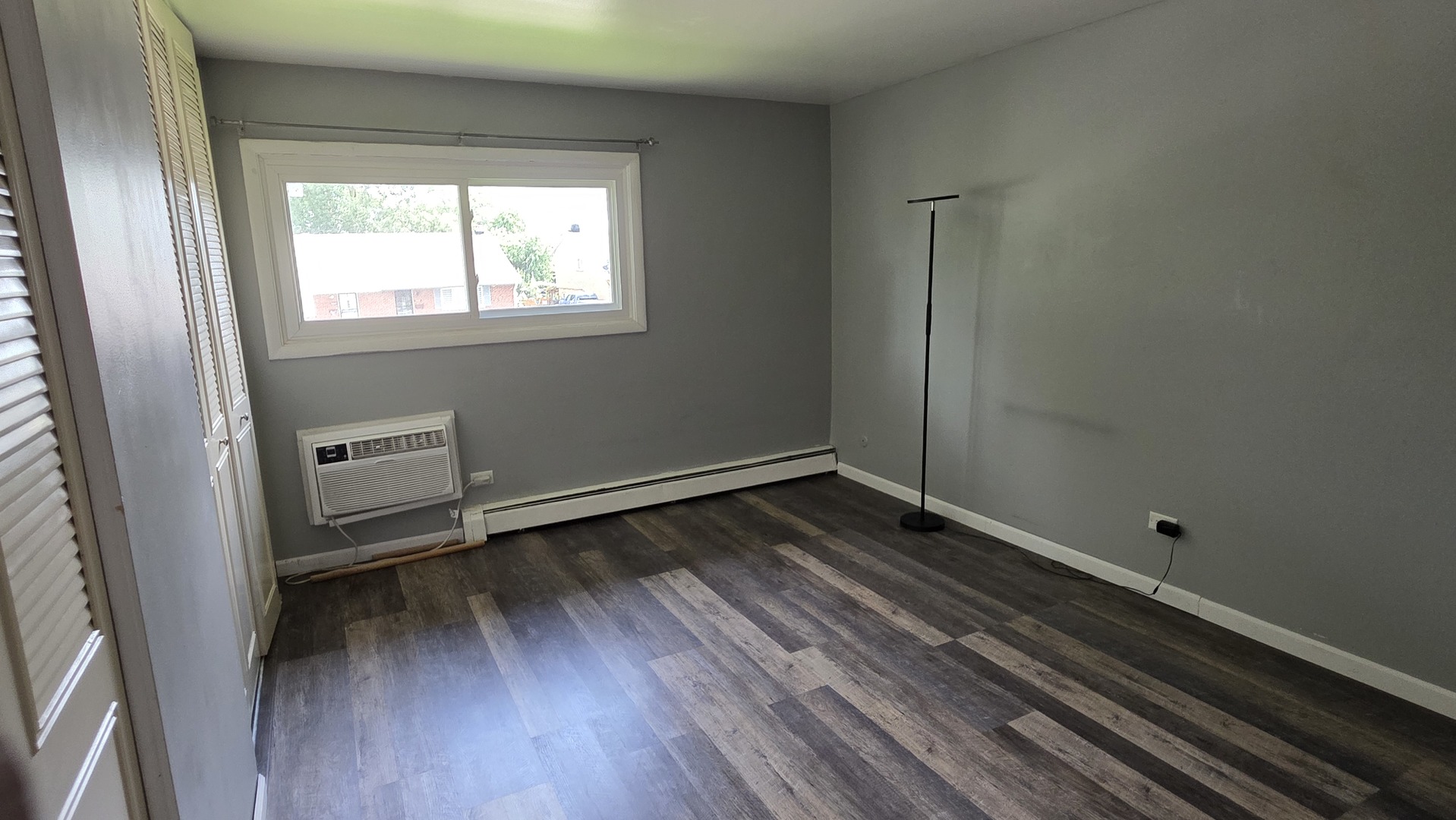 9446 Dee Road, Unit 2E Des Plaines, IL 60016 - Photo 20 of 37 a view of a room with wooden floor and a window