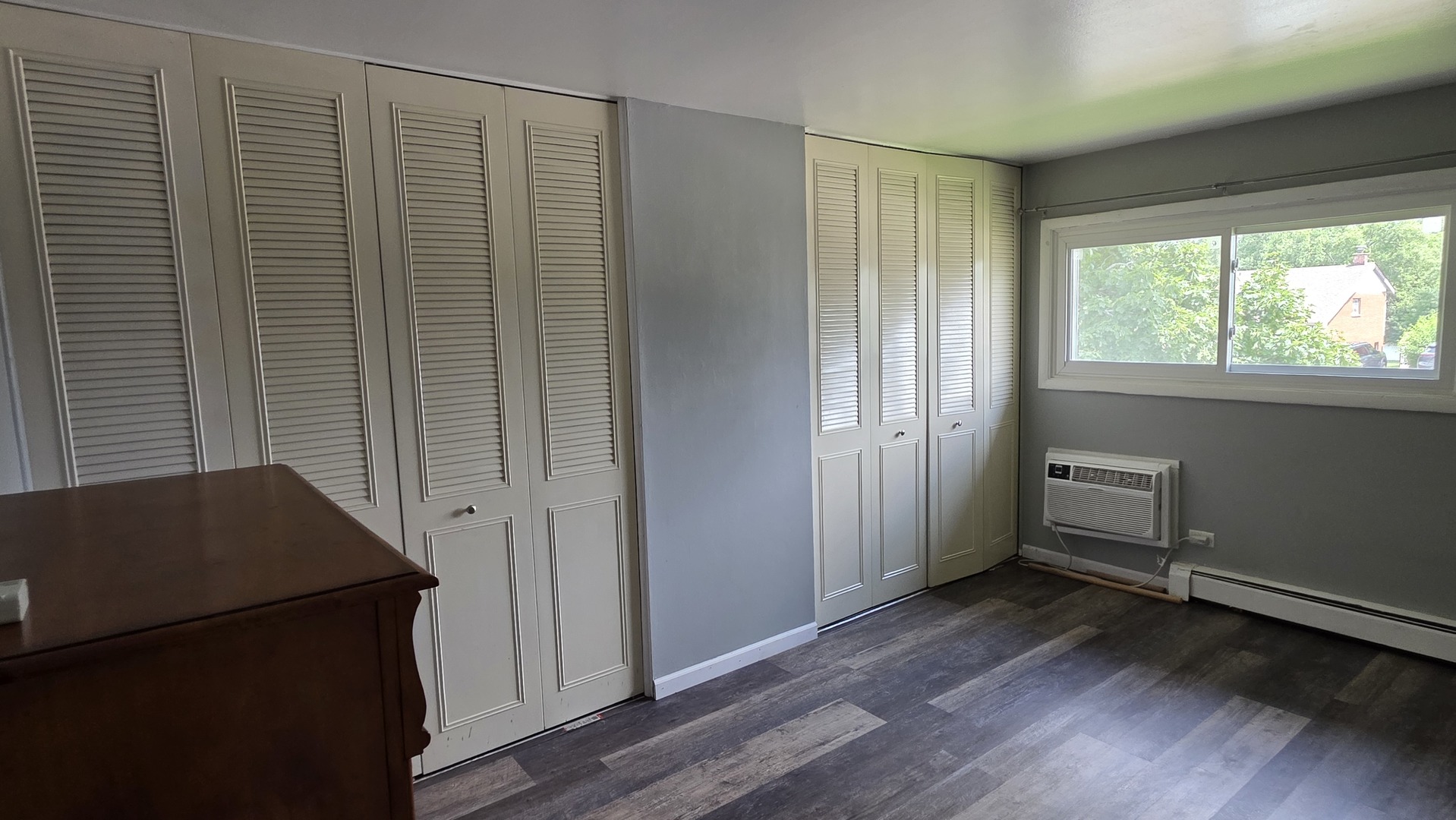 9446 Dee Road, Unit 2E Des Plaines, IL 60016 - Photo 22 of 37 an empty room with wooden floor and windows