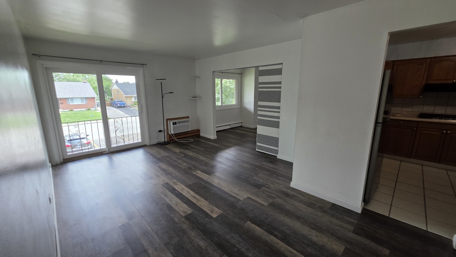 9446 Dee Road, Unit 2E Des Plaines, IL 60016 - Photo 28 of 37 an empty room with wooden floor and windows