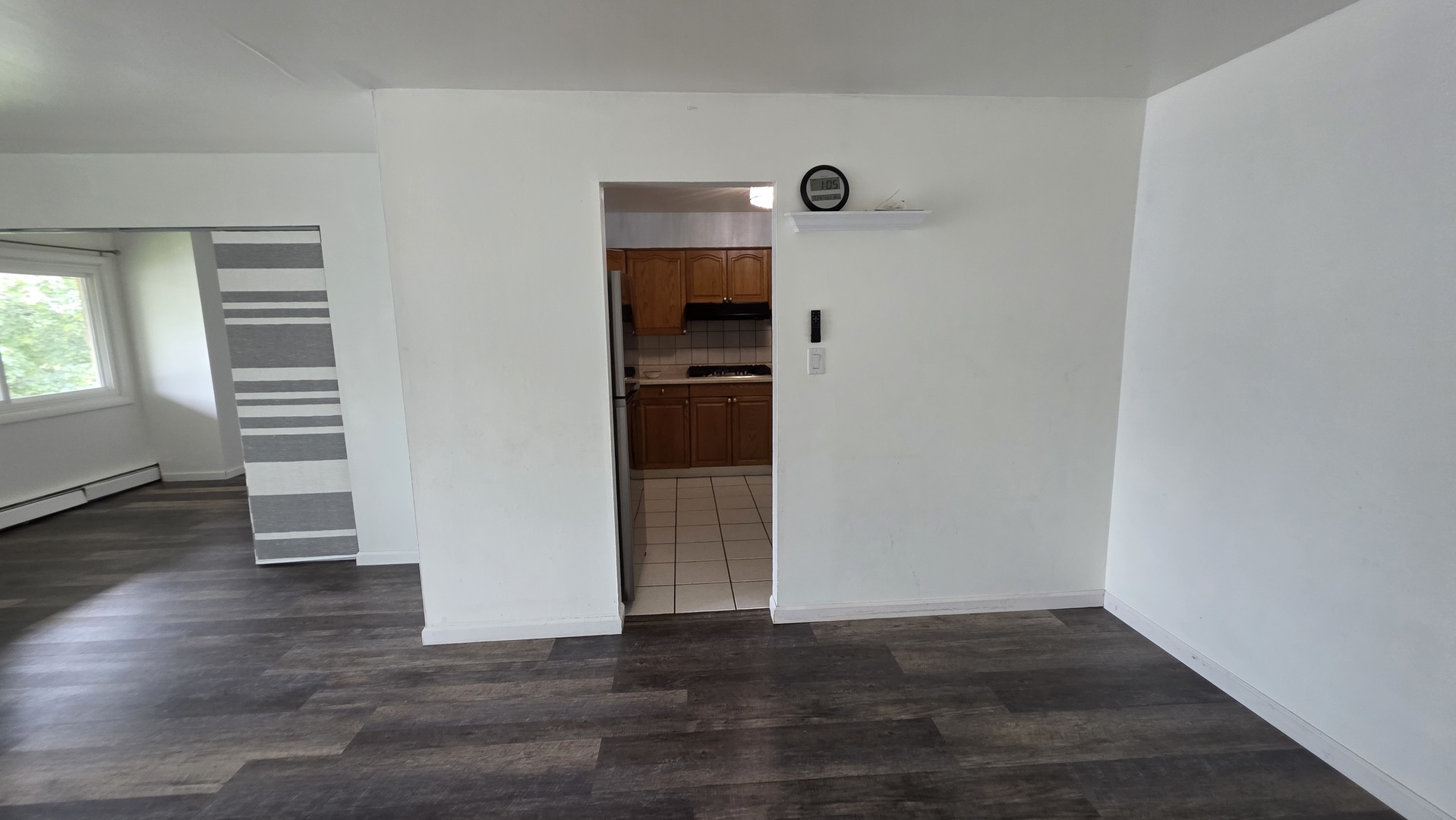 9446 Dee Road, Unit 2E Des Plaines, IL 60016 - Photo 29 of 37 an empty room with wooden floor and windows