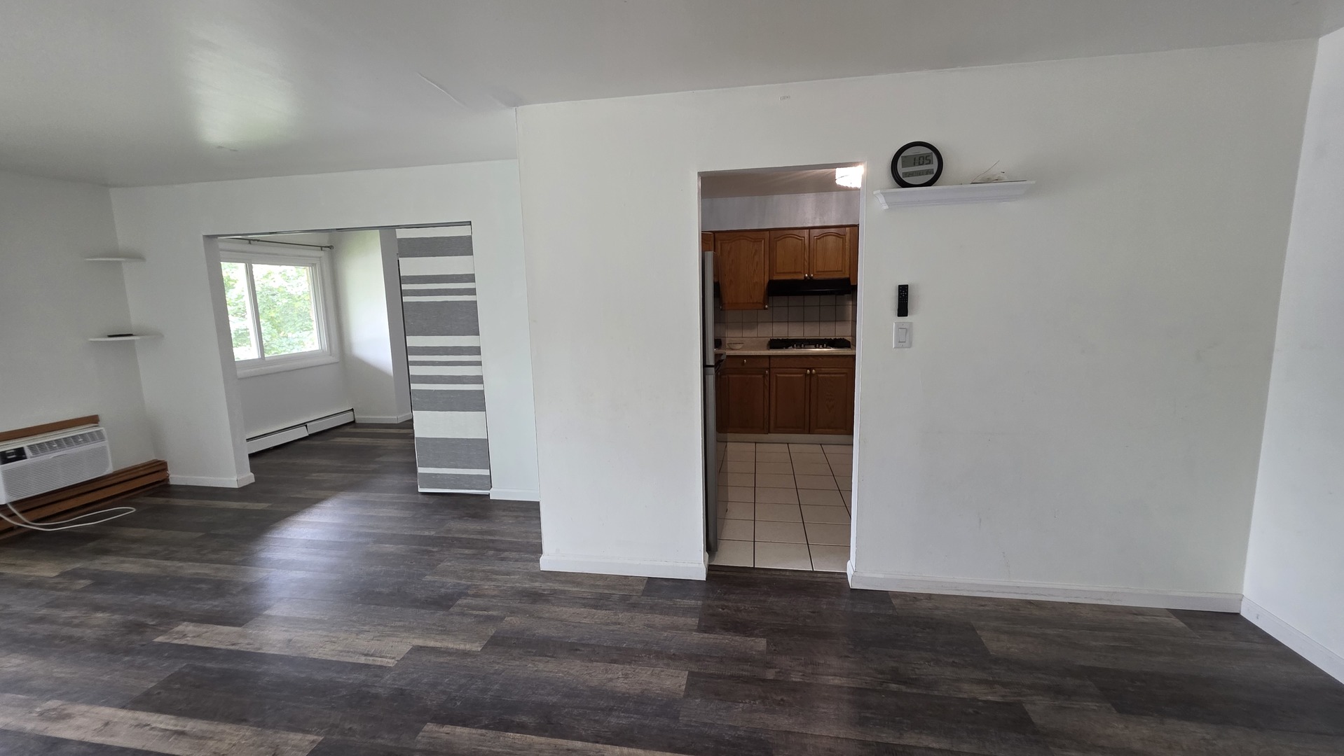 9446 Dee Road, Unit 2E Des Plaines, IL 60016 - Photo 30 of 37 an empty room with wooden floor and windows