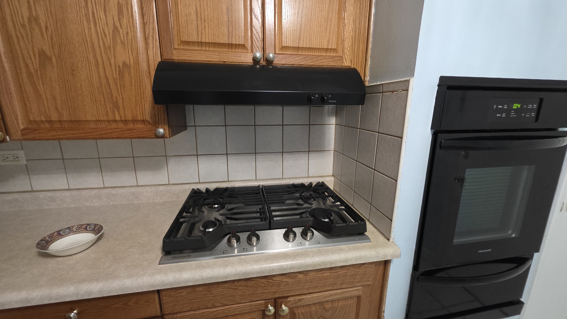 9446 Dee Road, Unit 2E Des Plaines, IL 60016 - Photo 34 of 37 a close view of a stove a microwave and cabinets in a kitchen