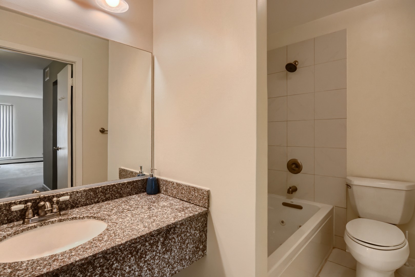1931 Prairie Square, Unit 331 Schaumburg, IL 60173 - Photo 13 of 19 a bathroom with a granite countertop sink a toilet a mirror a bathtub and shower