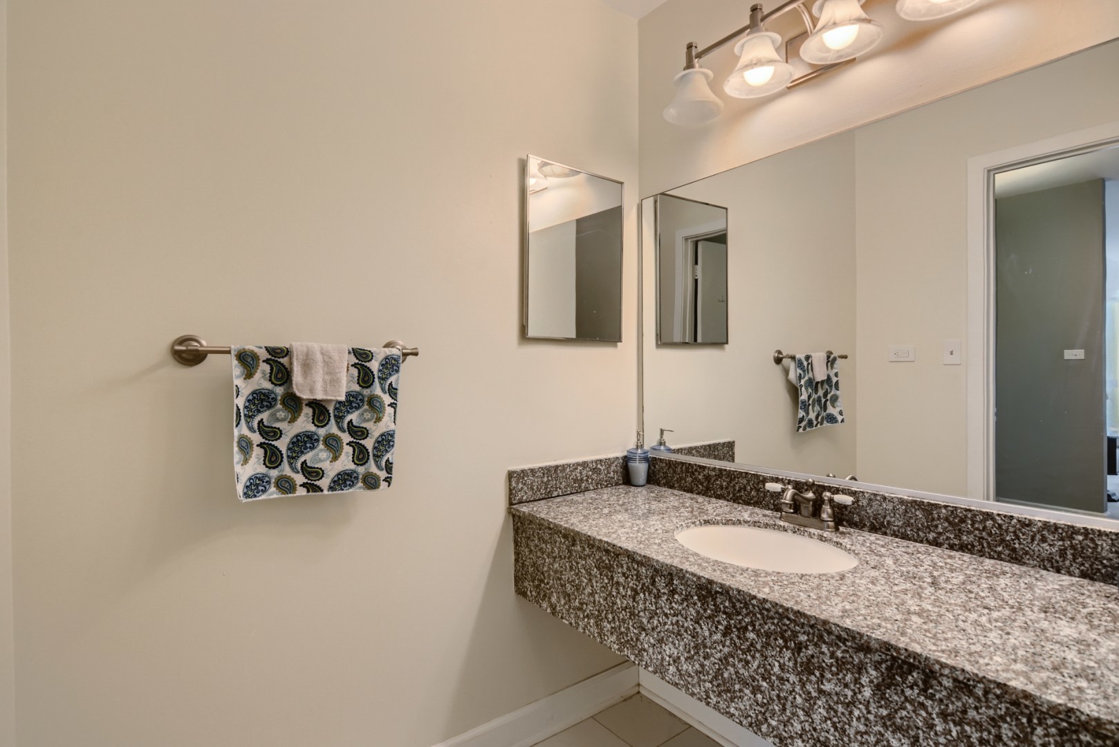 1931 Prairie Square, Unit 331 Schaumburg, IL 60173 - Photo 14 of 19 a bathroom with a granite countertop sink and a mirror