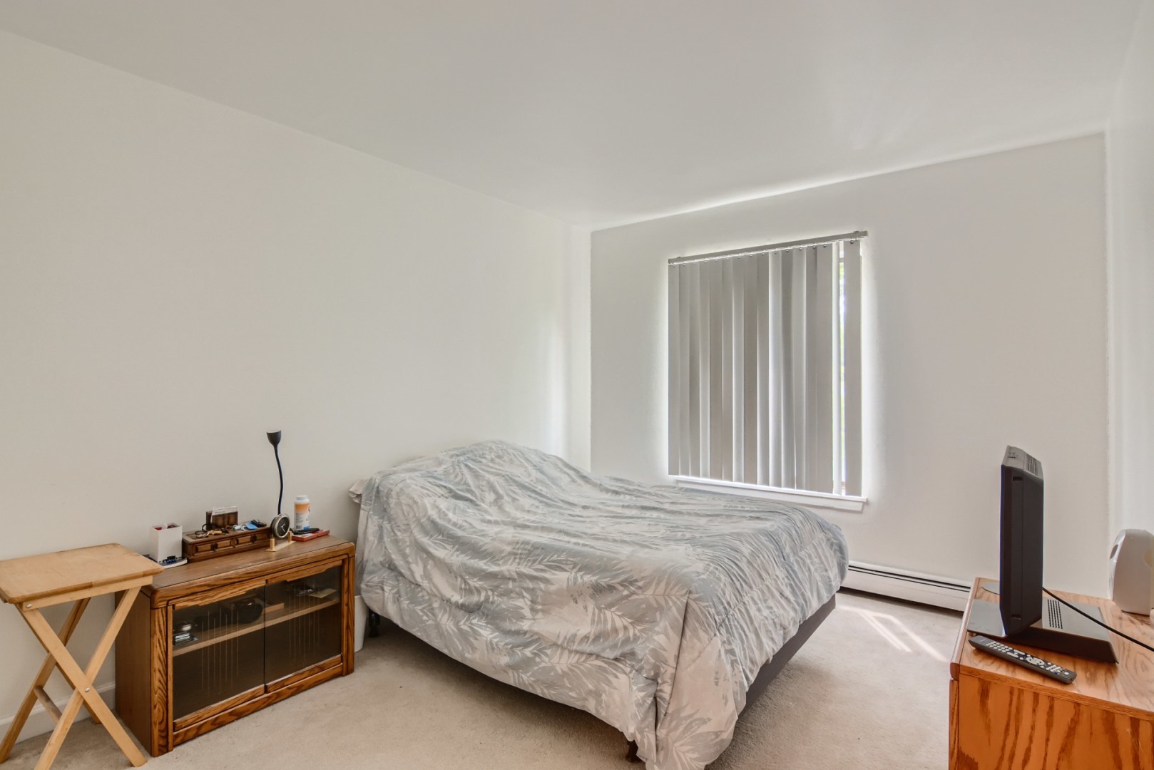 1931 Prairie Square, Unit 331 Schaumburg, IL 60173 - Photo 15 of 19 a bedroom with a bed and a tv on the dresser