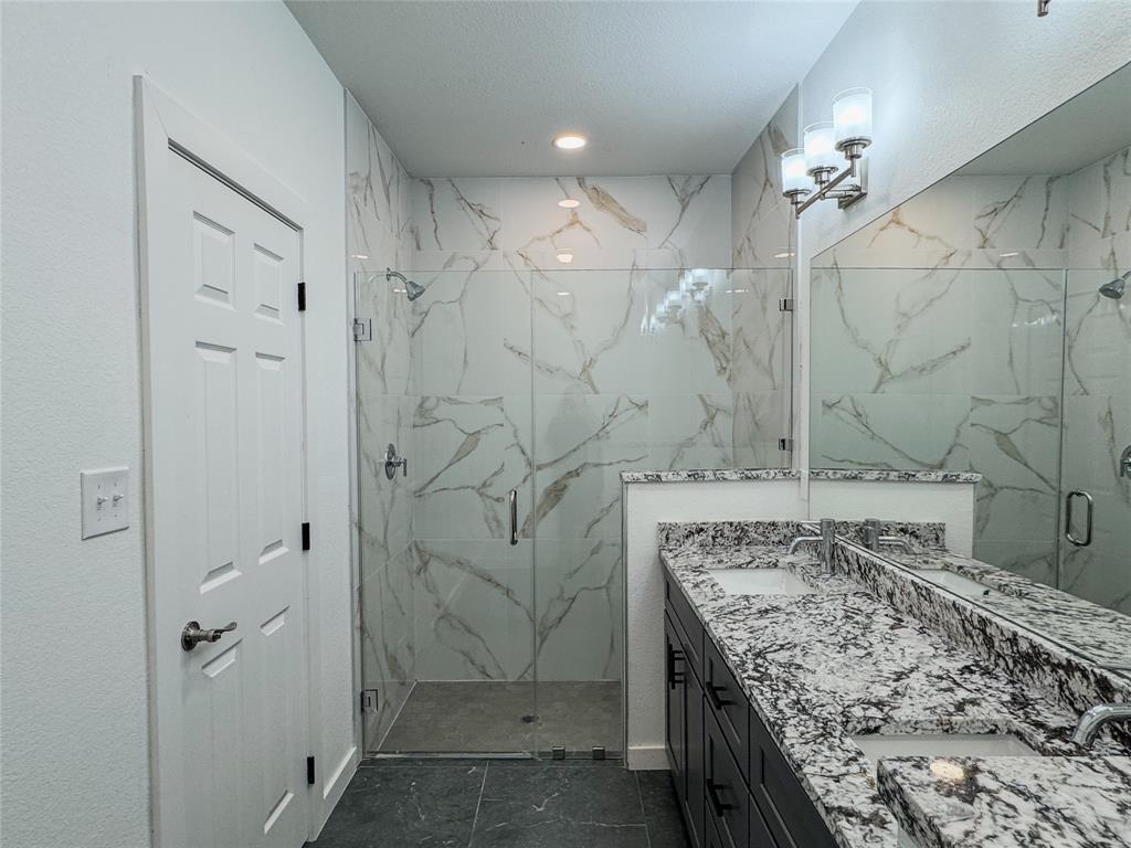 350 Lucy Road Greenville, TX 75402 - Photo 14 of 16 a bathroom with a granite countertop sink and shower