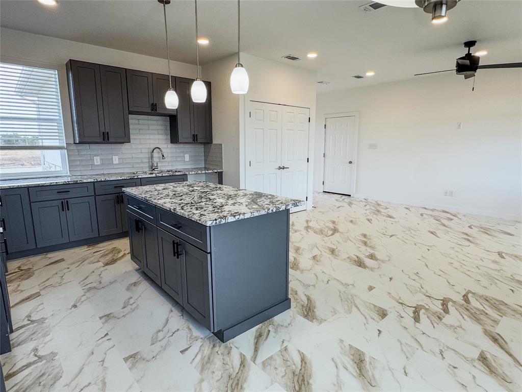 350 Lucy Road Greenville, TX 75402 - Photo 3 of 16 a kitchen with stainless steel appliances granite countertop a sink stove and refrigerator