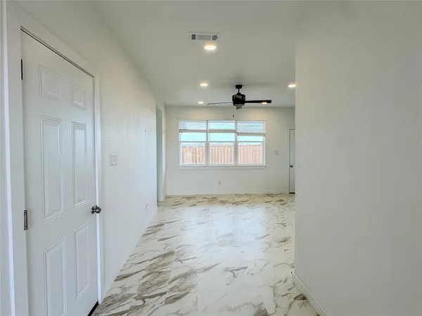 a view of a room with a window and ceiling fan