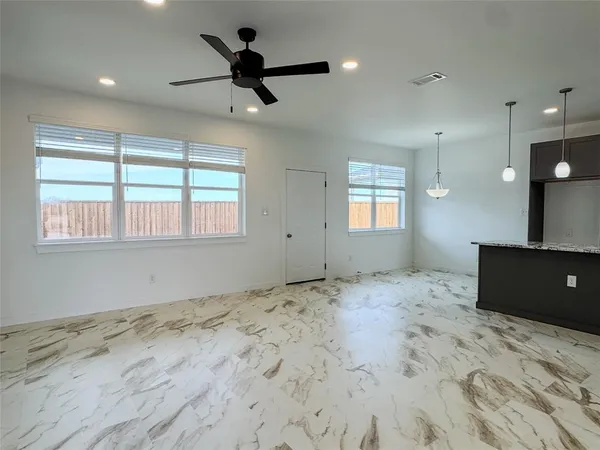 a bathroom with a granite countertop sink a toilet and shower