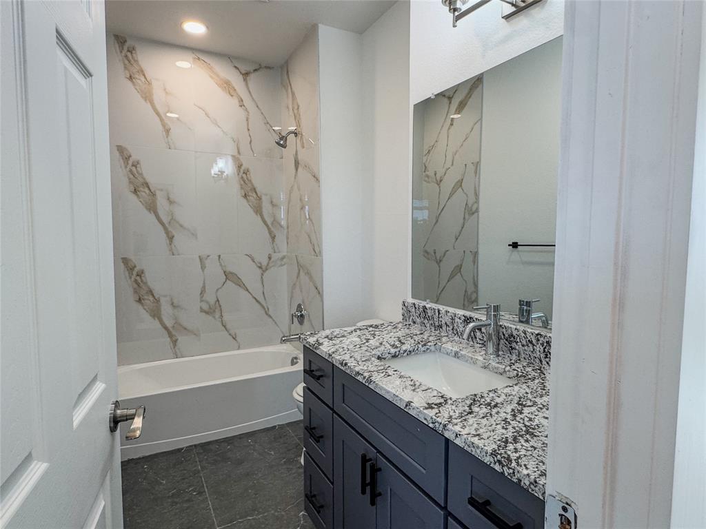 350 Lucy Road Greenville, TX 75402 - Photo 9 of 16 a bathroom with a granite countertop sink a toilet and shower