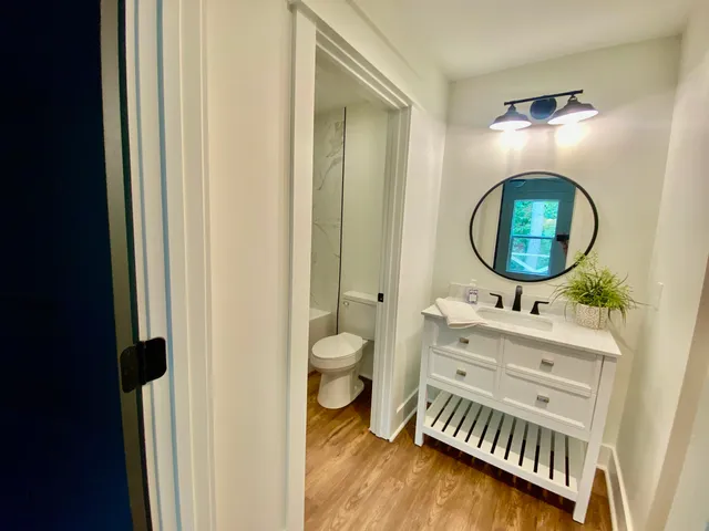 a bathroom with a toilet a sink and a mirror