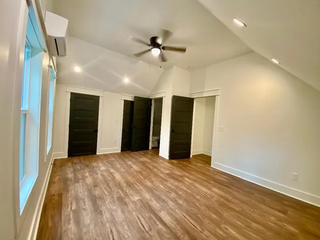 a view of an empty room with a ceiling fan