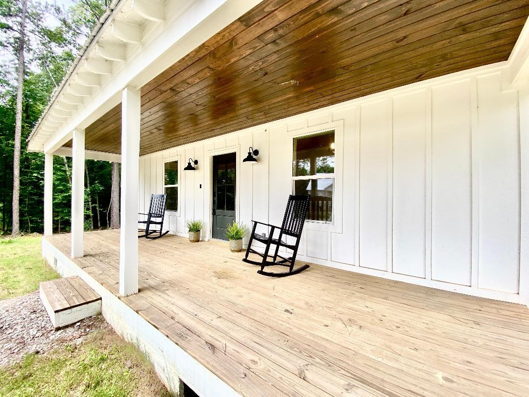 265 Rock Quarry Way Counce, TN 38326 - Photo 15 of 17 a view of a patio with wooden floor and a table and chairs