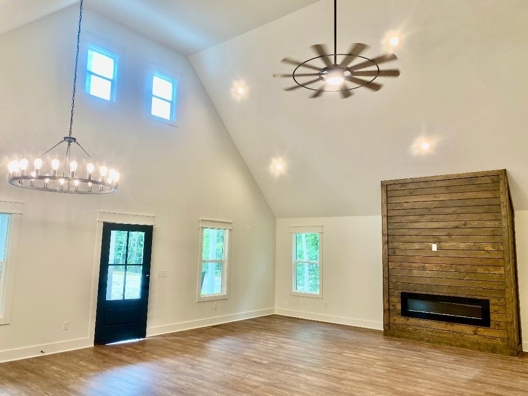 265 Rock Quarry Way Counce, TN 38326 - Photo 7 of 17 a view of a livingroom with a chandelier fan and windows