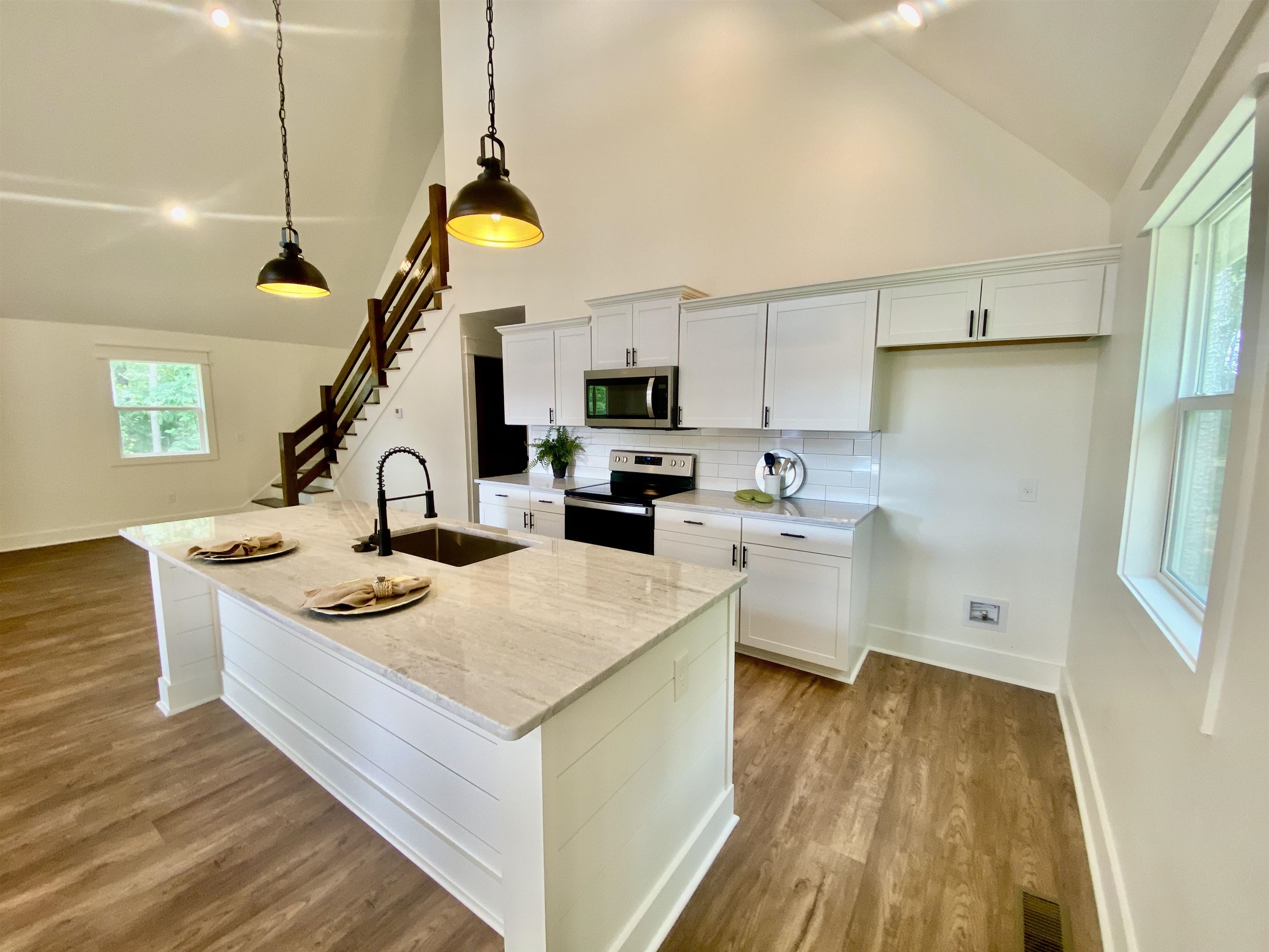 265 Rock Quarry Way Counce, TN 38326 - Photo 8 of 17 a kitchen that has a lot of cabinets a sink and wooden floor