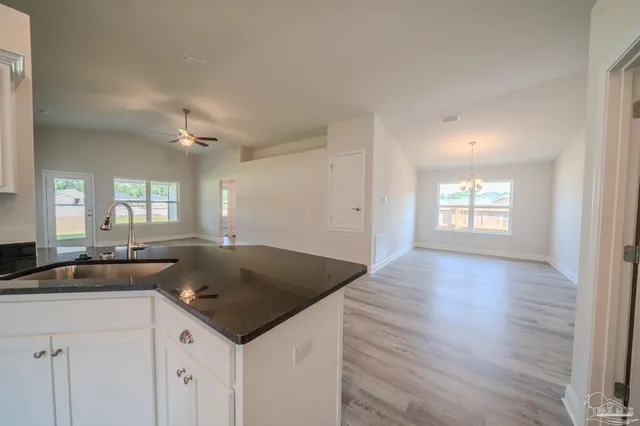 a kitchen with granite countertop a sink and a stove