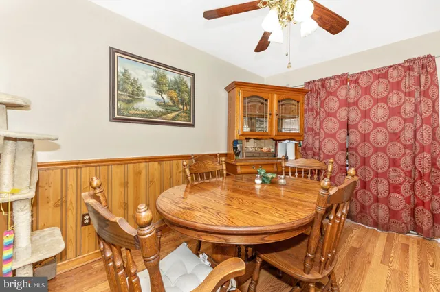 a view of a dining room with furniture and a chandelier