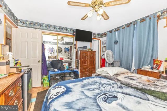 a bedroom with a bed dresser and a flat tv screen