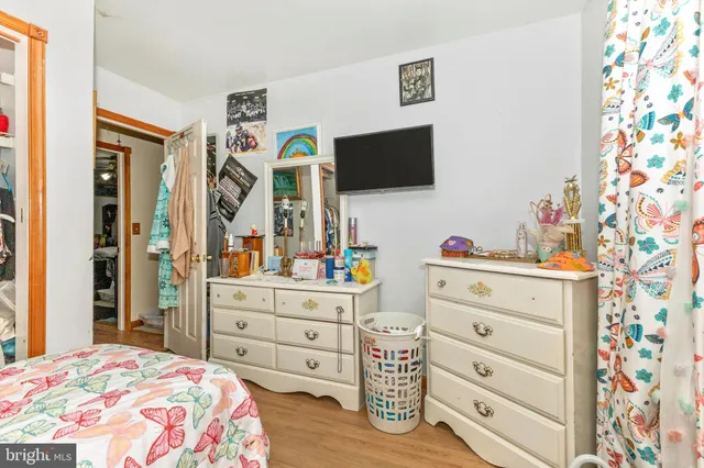 a bedroom with a bed and a dresser in it