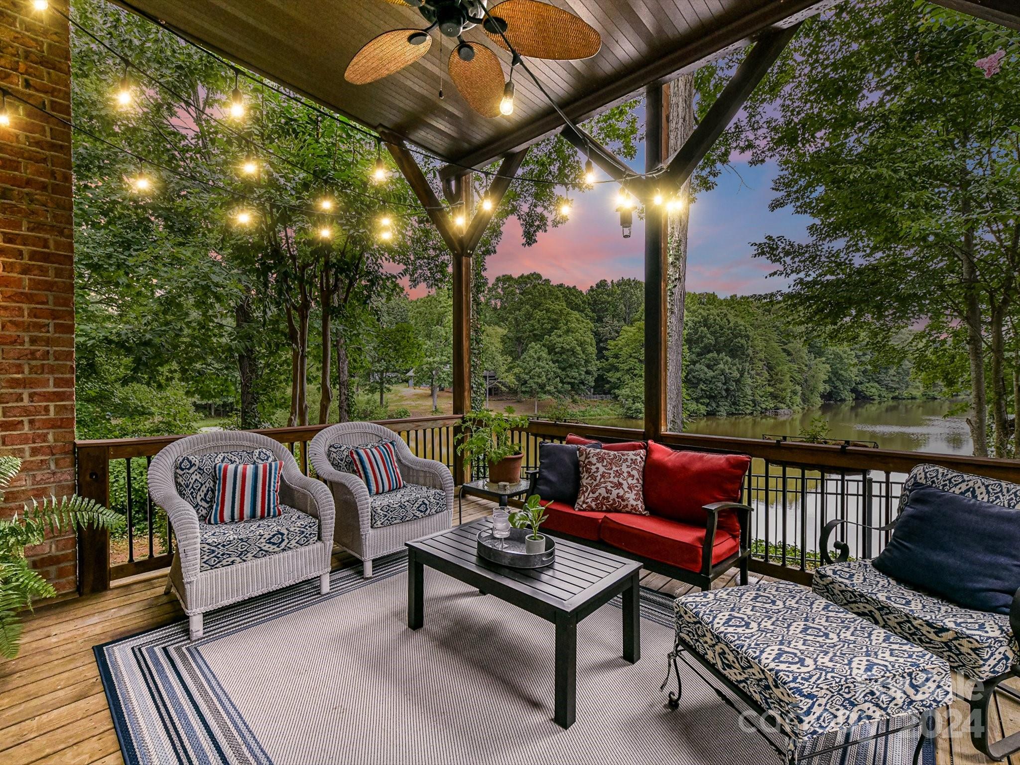 146 Canterbury Crossing Fort Mill, SC 29708 - Photo 2 of 48 a view of a patio with couches table and chairs with wooden floor and fence