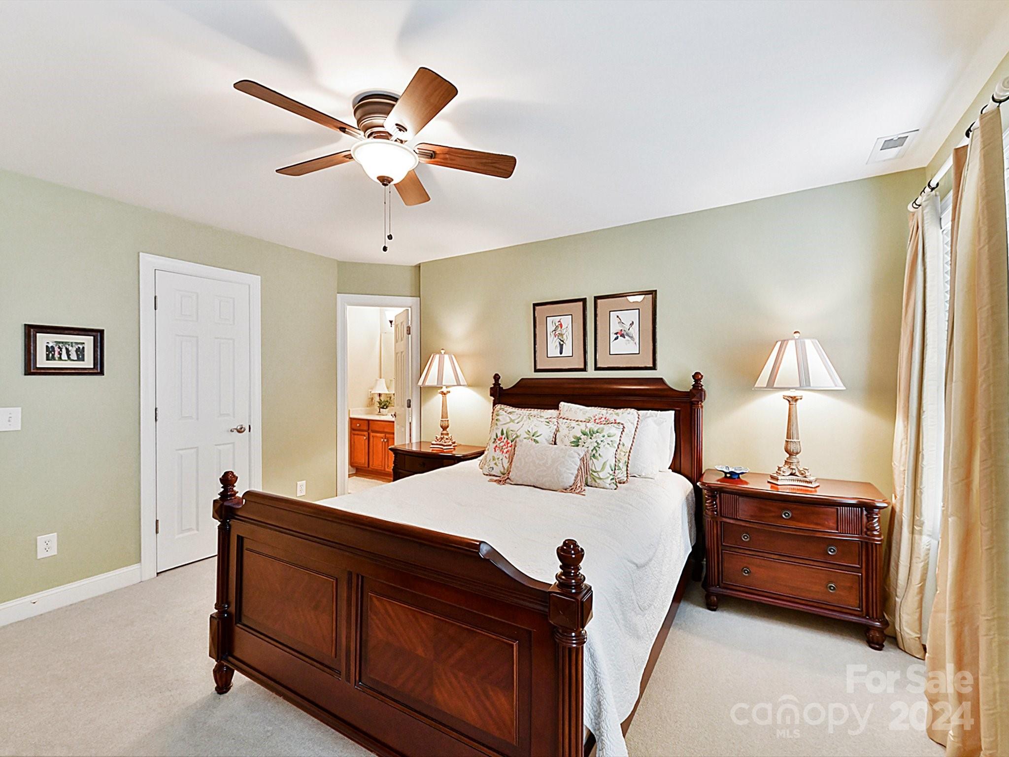 146 Canterbury Crossing Fort Mill, SC 29708 - Photo 25 of 48 a bed room with a bed and a chandelier