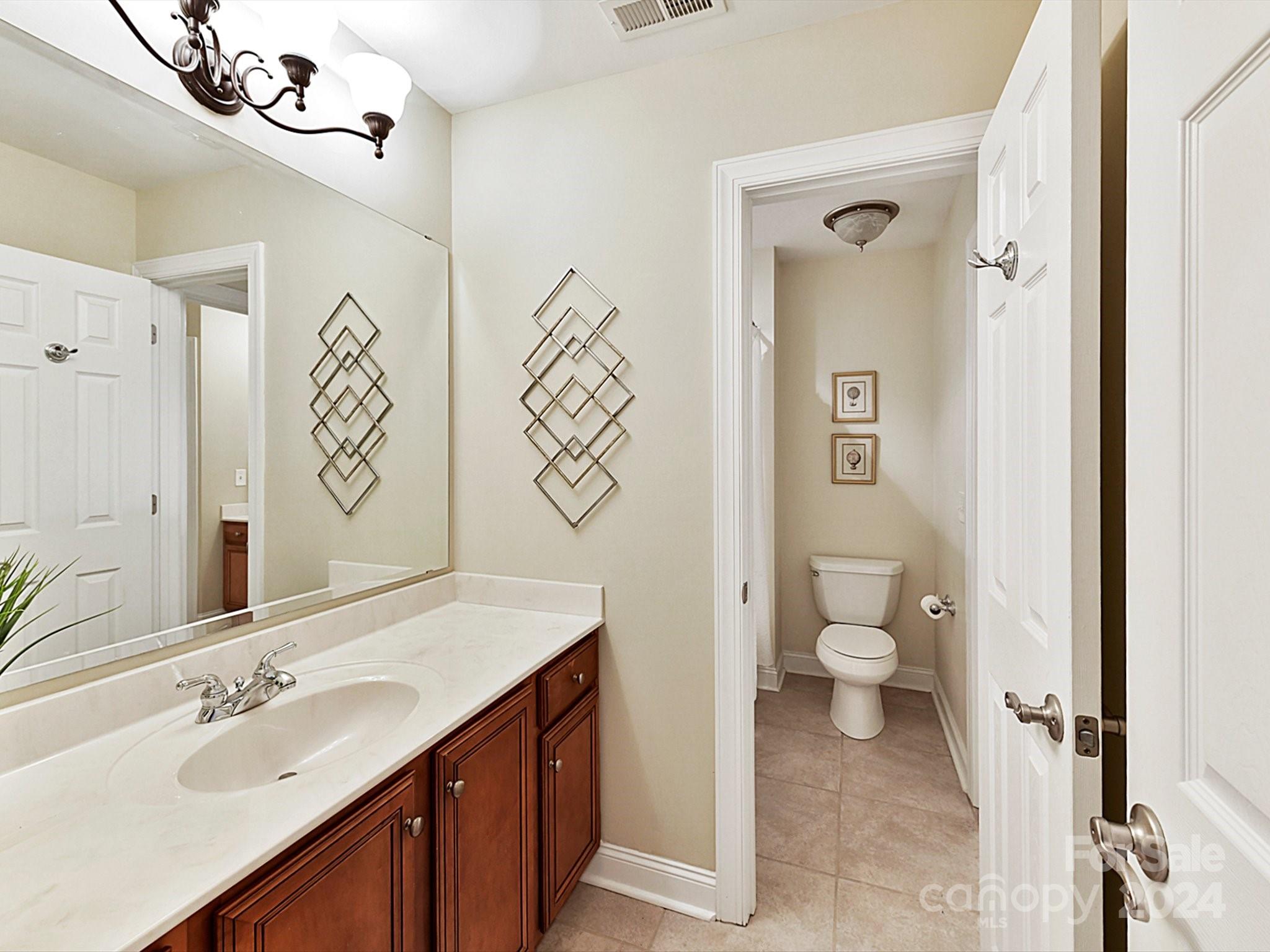 146 Canterbury Crossing Fort Mill, SC 29708 - Photo 26 of 48 a bathroom with a toilet sink and mirror