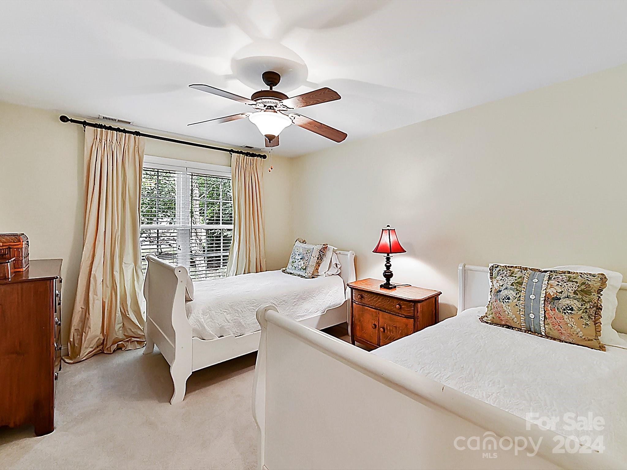 146 Canterbury Crossing Fort Mill, SC 29708 - Photo 27 of 48 a bedroom with a bed and a chandelier