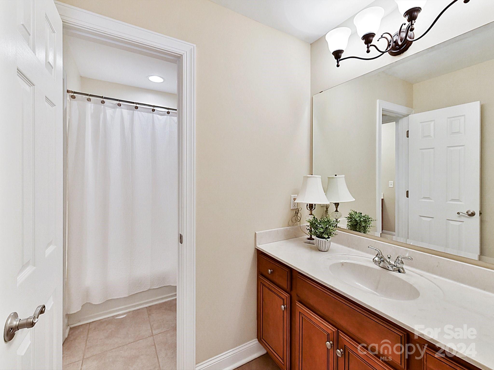 146 Canterbury Crossing Fort Mill, SC 29708 - Photo 28 of 48 a bathroom with a double vanity sink and a mirror