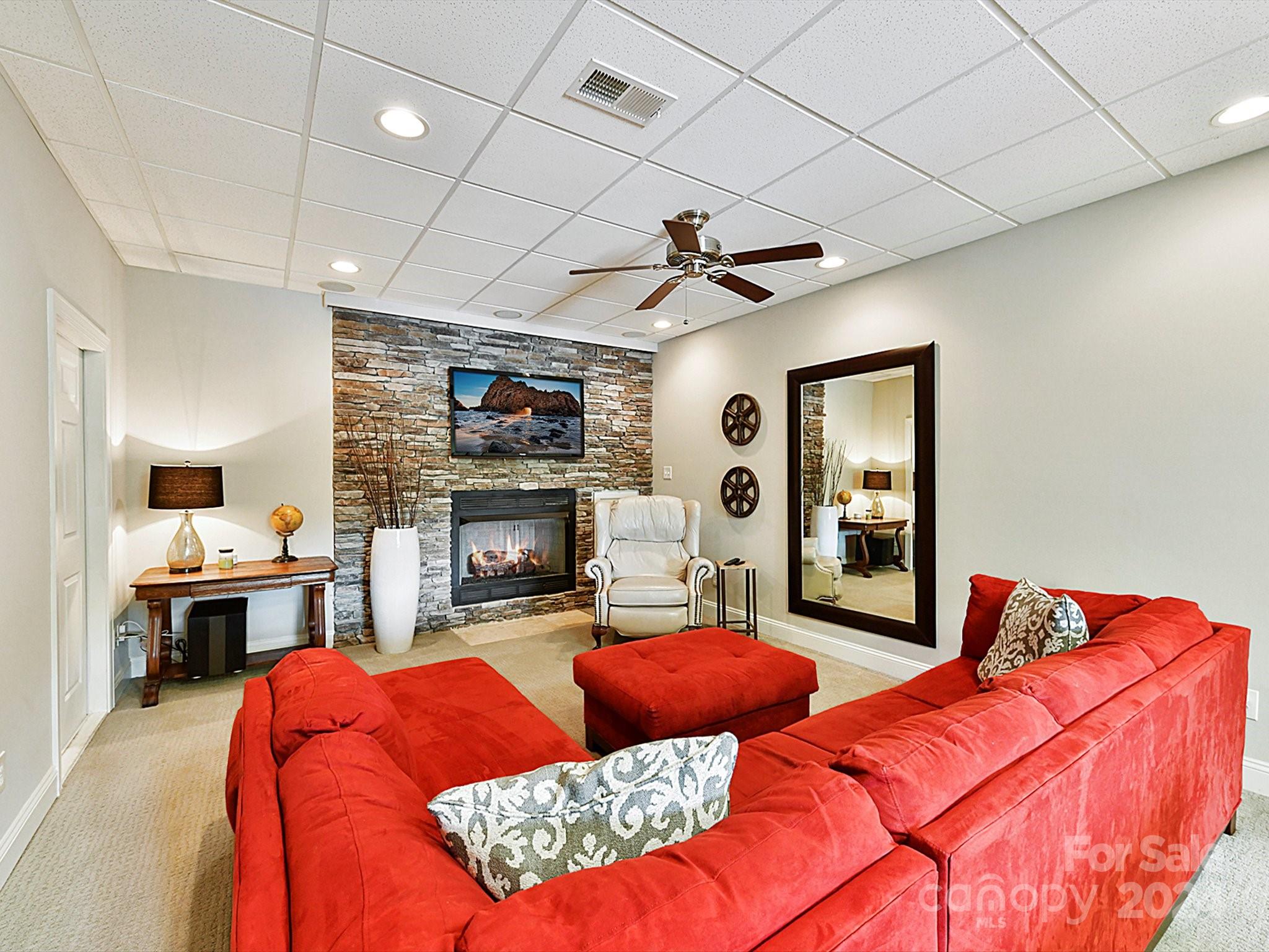 146 Canterbury Crossing Fort Mill, SC 29708 - Photo 31 of 48 a living room with furniture a fireplace and a flat screen tv