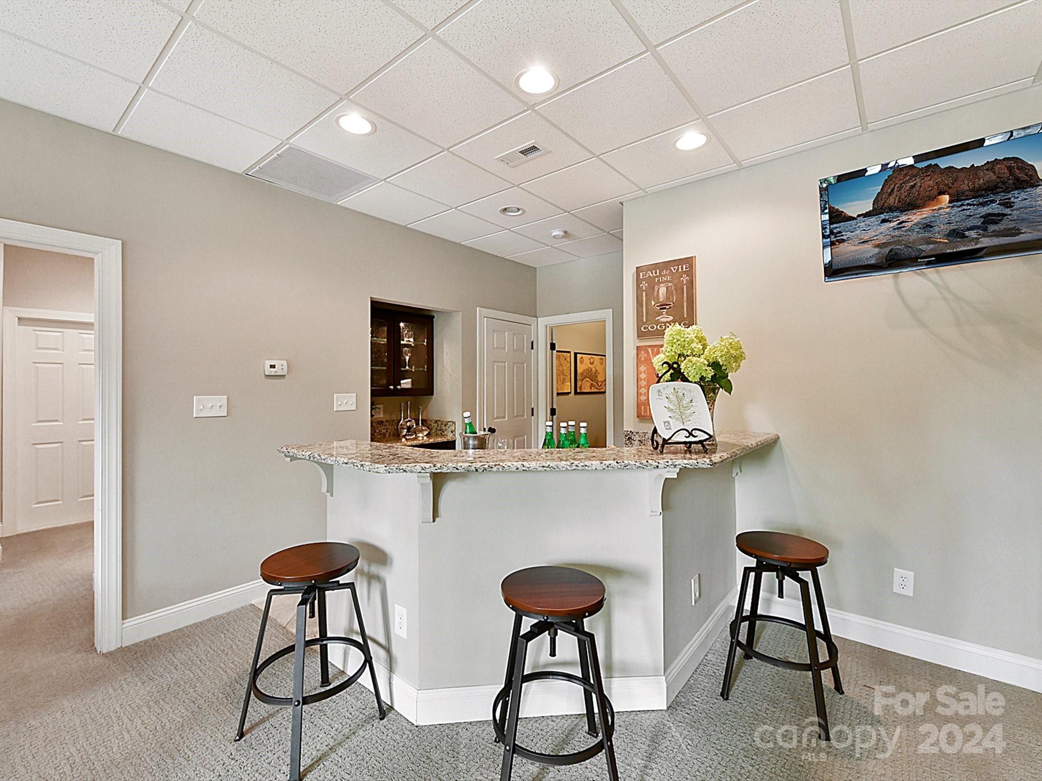 146 Canterbury Crossing Fort Mill, SC 29708 - Photo 34 of 48 a kitchen with stainless steel appliances granite countertop a refrigerator a stove a dining table and chairs with wooden floor