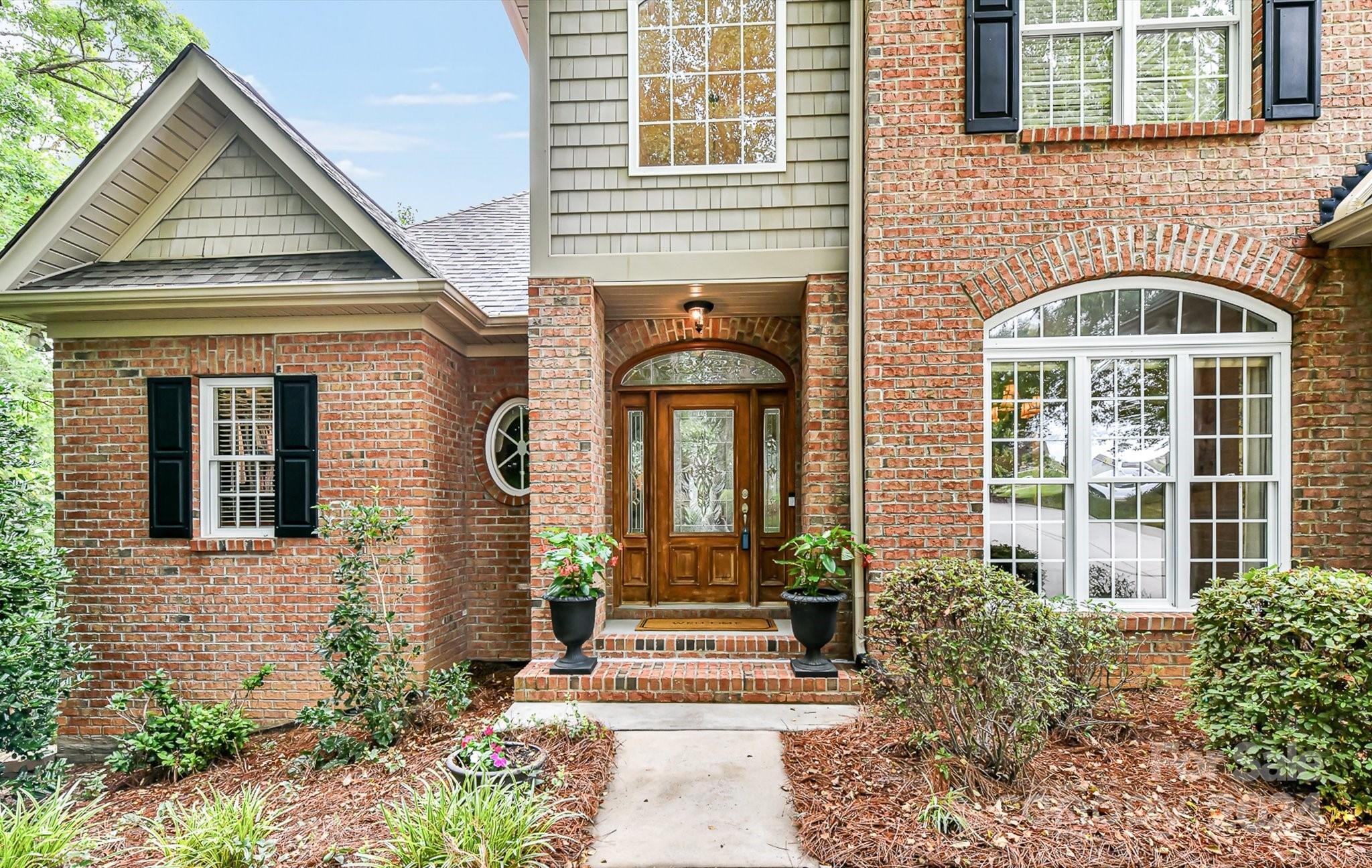 146 Canterbury Crossing Fort Mill, SC 29708 - Photo 4 of 48 a front view of a house with a garden