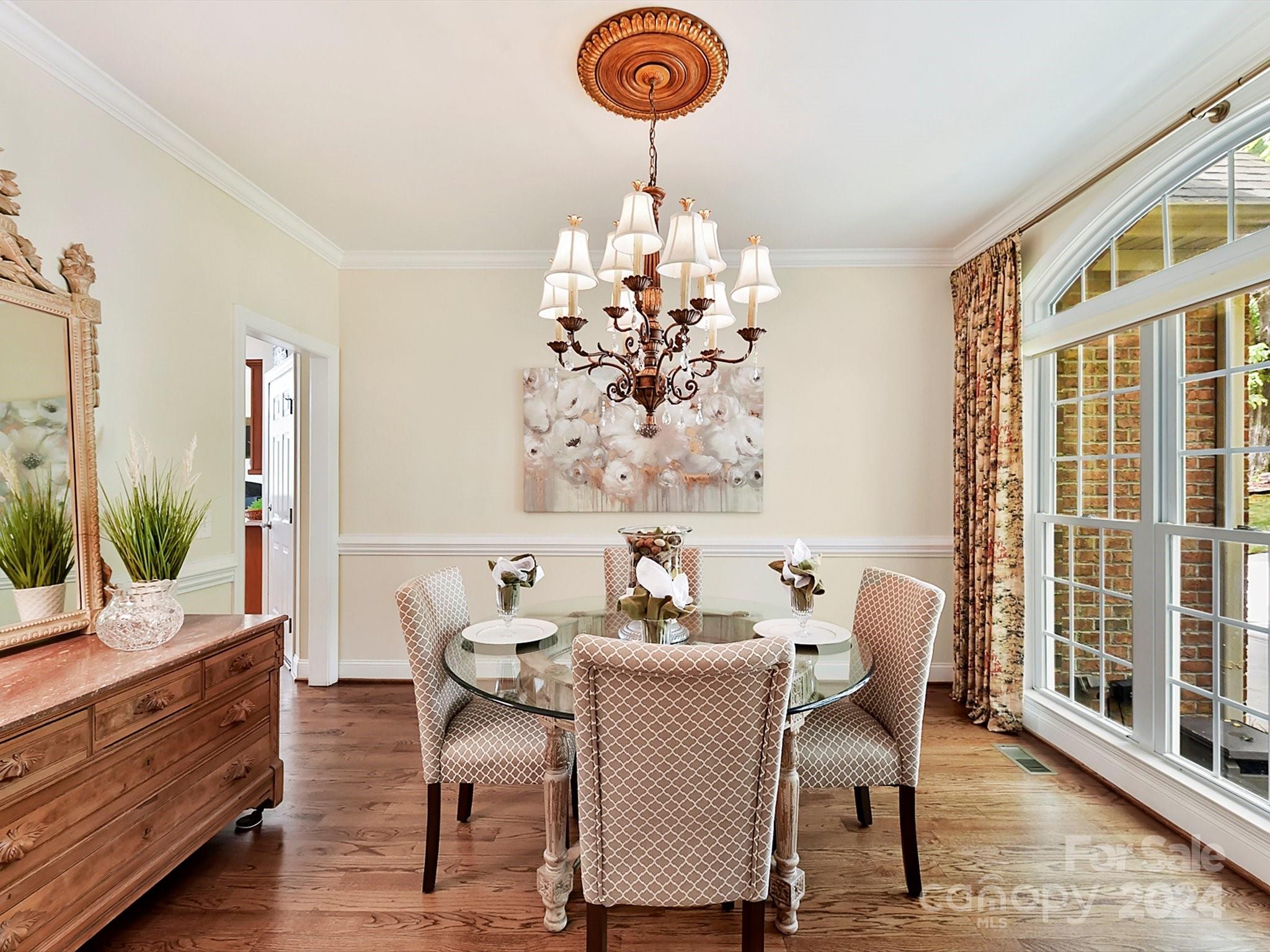 146 Canterbury Crossing Fort Mill, SC 29708 - Photo 7 of 48 a dining room with furniture a chandelier and wooden floor