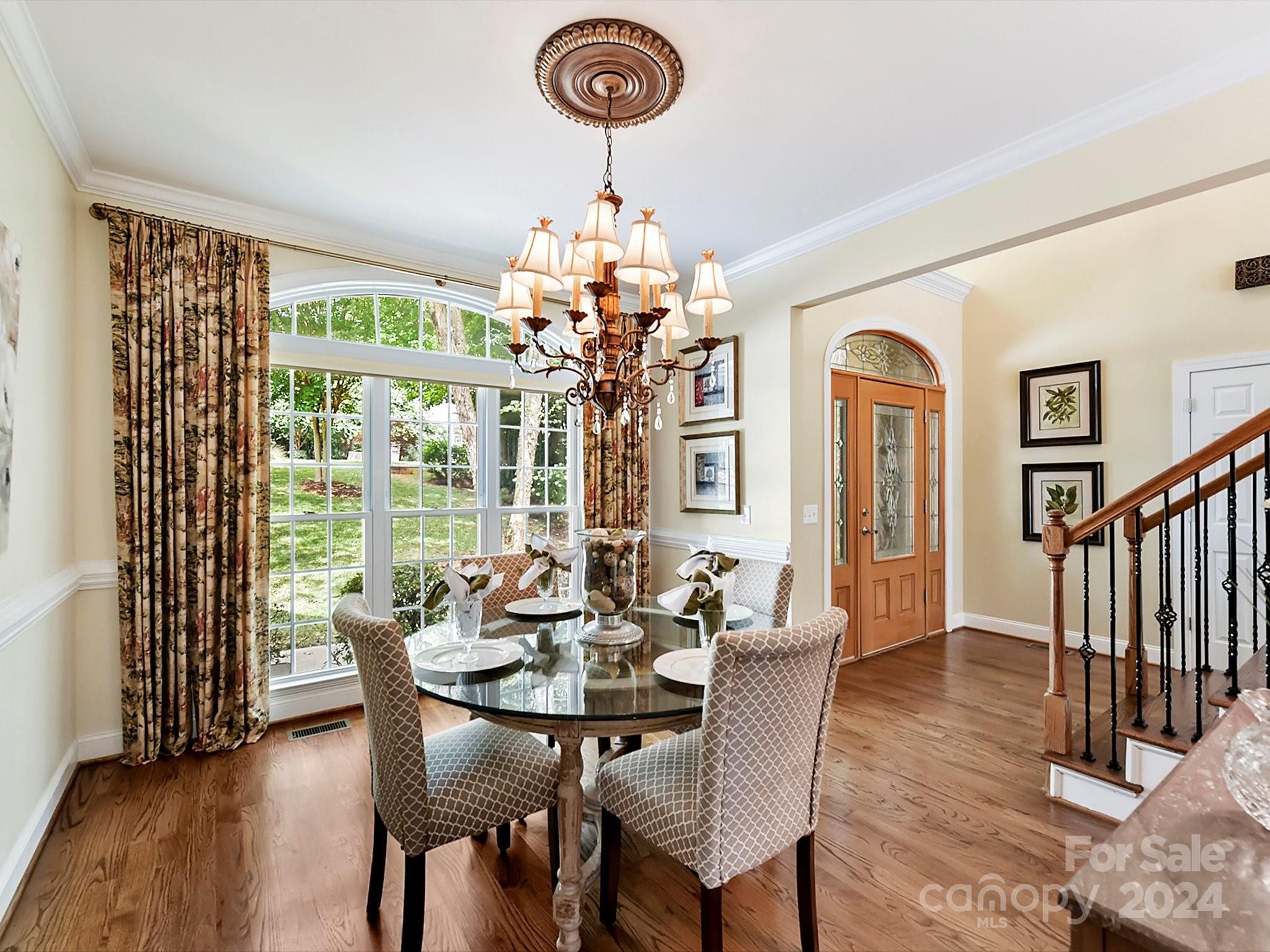 146 Canterbury Crossing Fort Mill, SC 29708 - Photo 8 of 48 a dining room with furniture a chandelier and wooden floor
