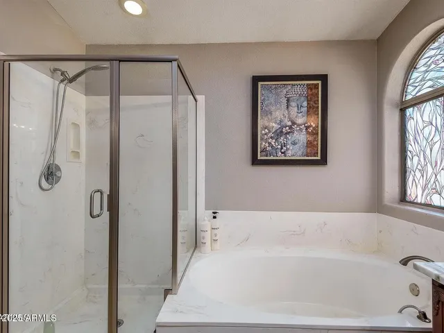 a bathroom with a bathtub and a shower