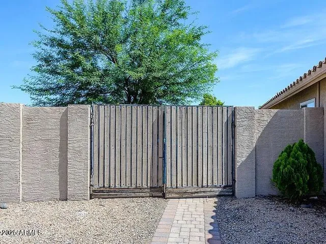 a wooden fence with trees in the background