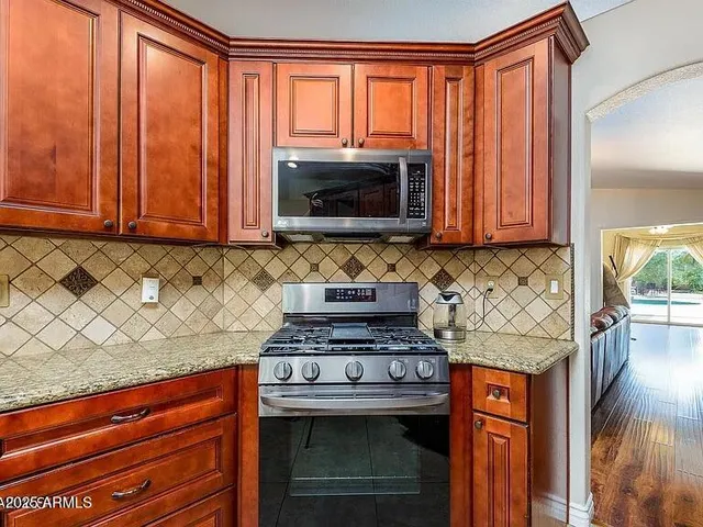 a stove top oven sitting inside of a kitchen