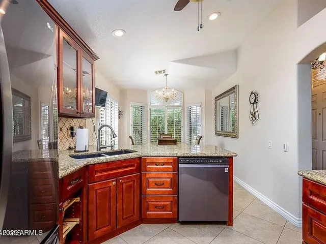 a kitchen with granite countertop a sink and cabinets