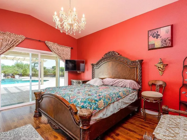 a bedroom with a bed and a large window with outer view