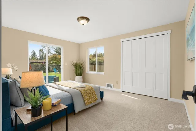 a bedroom with a bed and large window