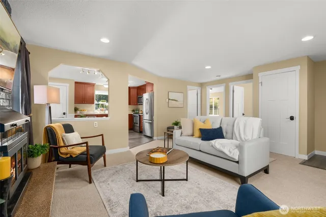 a living room with furniture and a large mirror