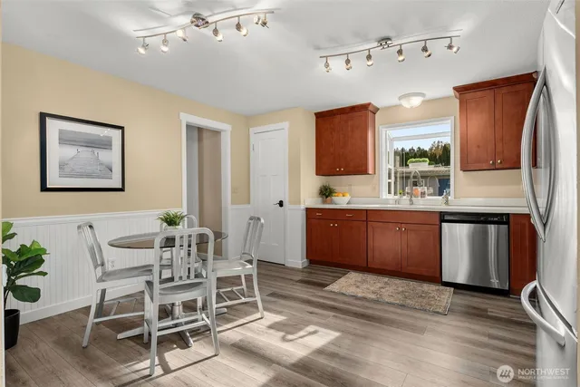 a kitchen with a sink and chairs