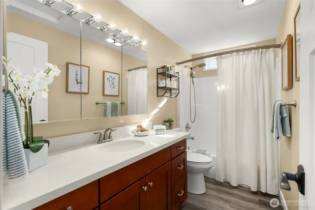 a bathroom with a double vanity sink and a mirror